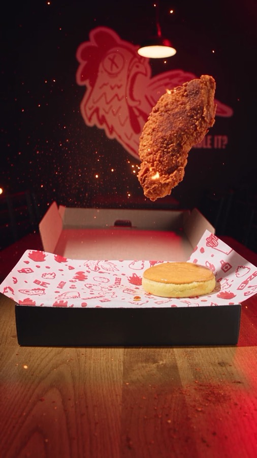 Fire in the Box ad: a chicken tender dropping into a box with sparks
